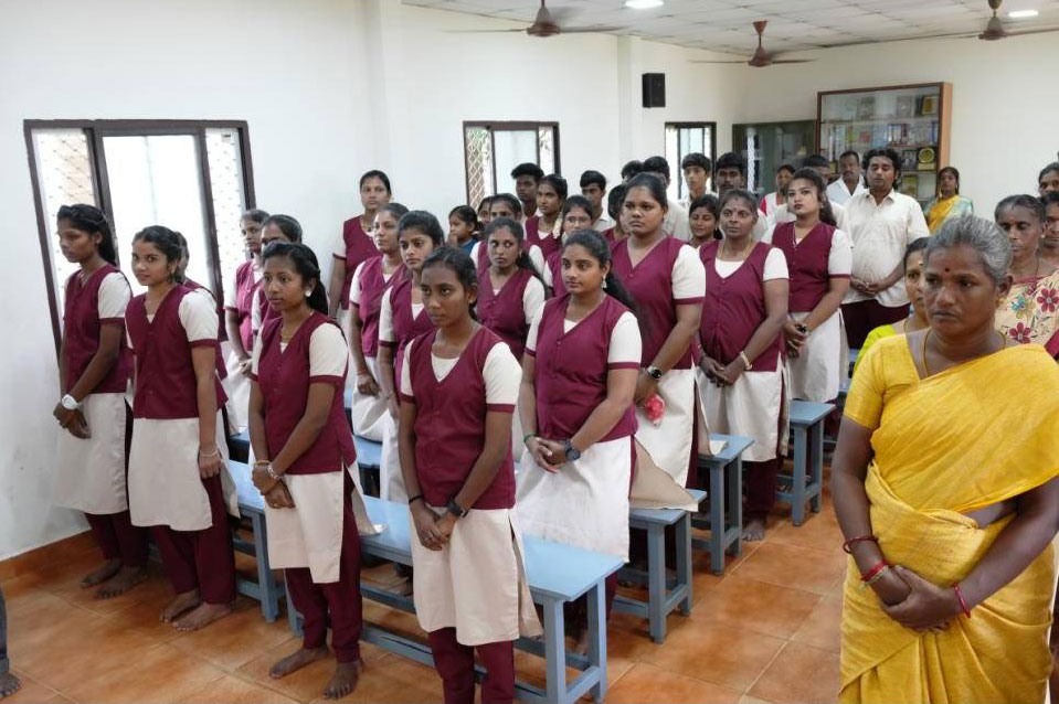 Students standing in a classroom at the Dr Chandran Devanesen Community College