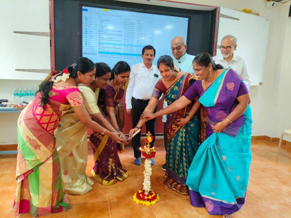 Guests and staff lighting the ceremonial lamp together