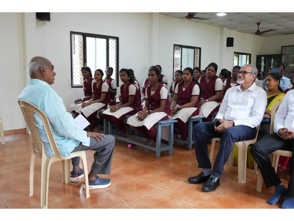 A guest speaking with students seated in the classroom