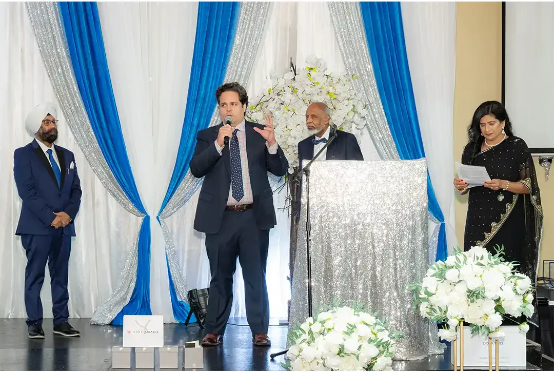 TREWO representative speaking at the podium during the Imagination Ball