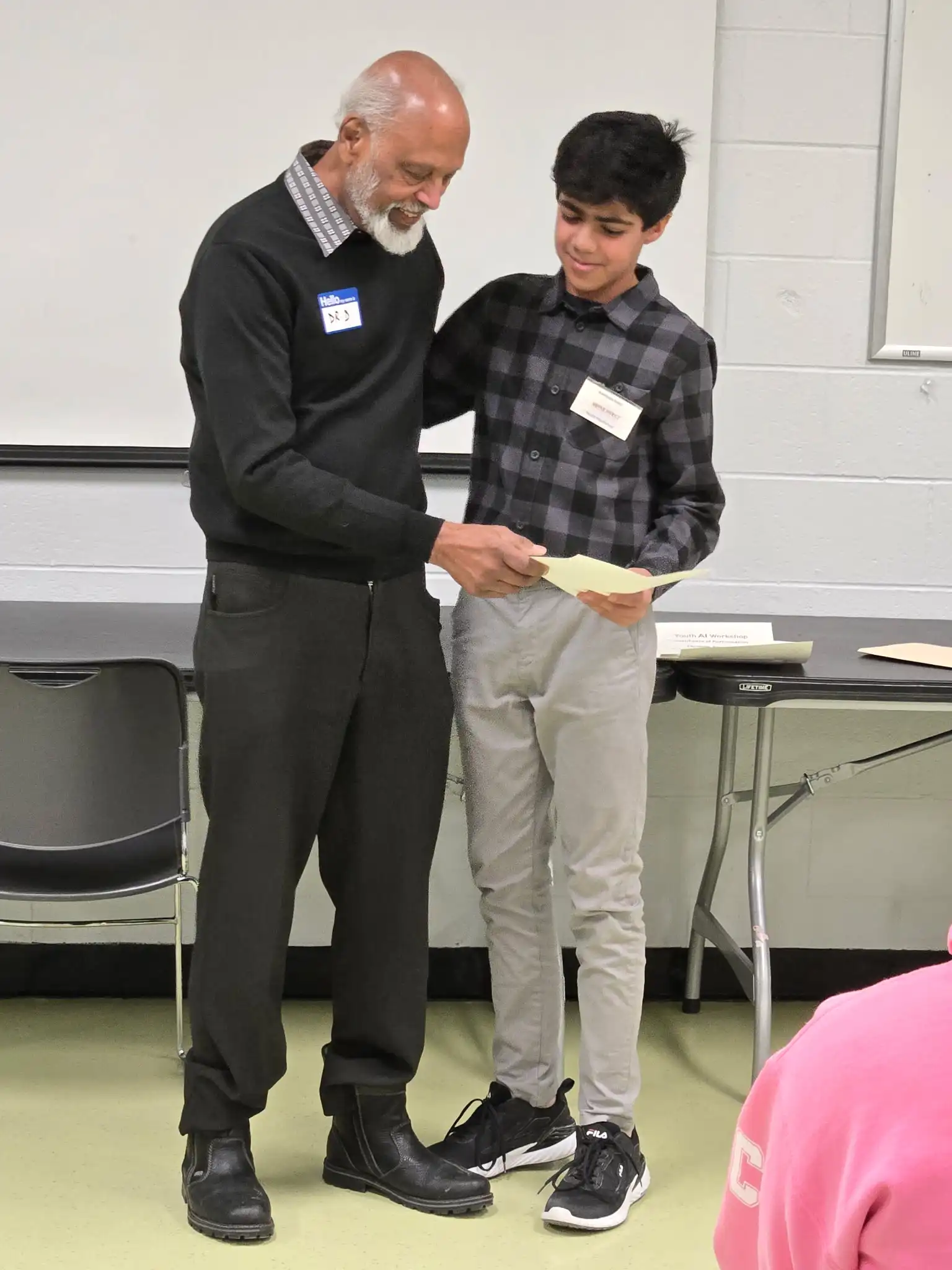 Dr. Sudi Devanesen presenting a certificate to a participant