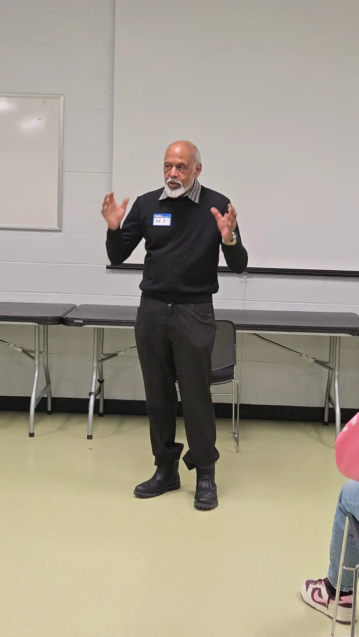 Dr. Sudi Devanesen speaking at the Mental Health Day event