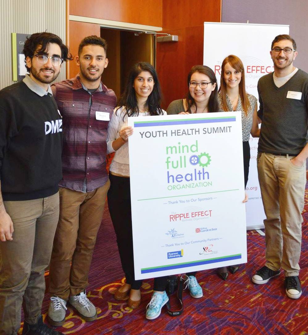 Attendees with the Youth Health Summit and Ripple Effect banners