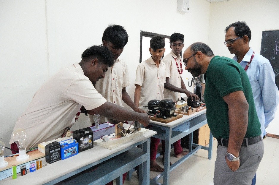 Students demonstrating their electrical training work to the visitors